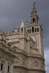 Seville, Spain - Mar 23, 2025: Walking in Seville. Cathedral. Streets, buildings. Lifestyle in the urban area. Cloudy spring day. Selective focus