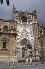 Seville, Spain - Mar 23, 2025: Walking in Seville. Cathedral. Streets, buildings. Lifestyle in the urban area. Cloudy spring day. Selective focus