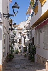 Marbella, Spain - Mar 30, 2025: Walking in Marbella. Streets, buildings. Lifestyle in the urban area. Sunny spring day. Selective focus