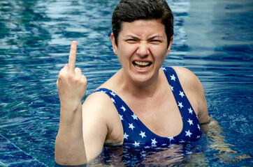 Woman Expressing Anger with an indecent gesture in Swimming Pool