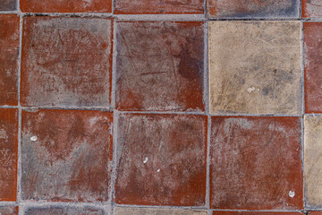 Colorful mosaic textures create a vibrant floor design in a sunlit courtyard