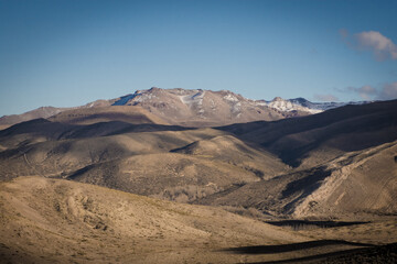 Fototapeta premium Mountains in the background with cloud shadows.
