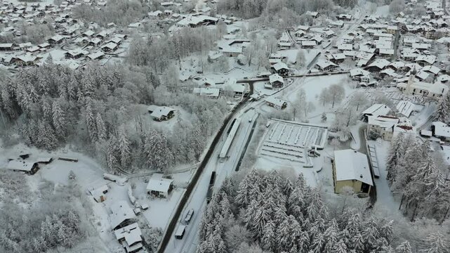 Aerial view of Bavarian Zugspitze Railway near Grainau in winter. Snow-covered landscapes, alpine beauty, cog railway and German Alps create breathtaking winter wonderland. Bayerische Zugspitzbahn. 