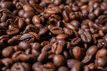 A detailed view of coffee beans being ground, showing off their chocolate texture that conveys the theme of coffee, energy and morning rituals.