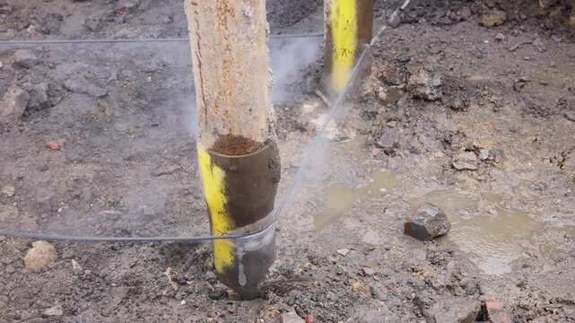Wire saw guide pulleys in action as spinning and guiding diamond wire cutting structural elements on building site