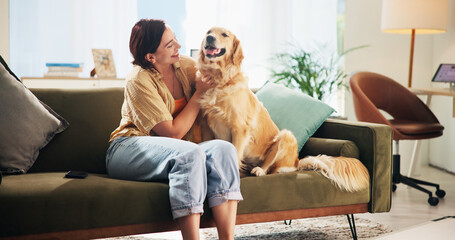 Woman, golden retriever and play on sofa in home, smile and bonding in morning for love in living...