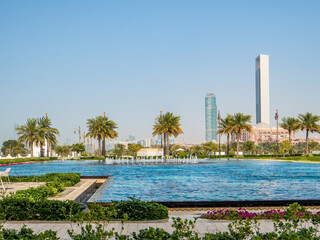 Abu Dhabi with palm trees and skyscrapers.