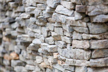 A wall made of stone blocks with a rough texture