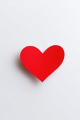 Fototapeta premium image of minimalist red heart symbol on white backdrop
