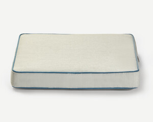 Comfortable pet bed resting on white background