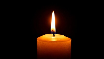 One candle burning slowly isolated on pitch black background