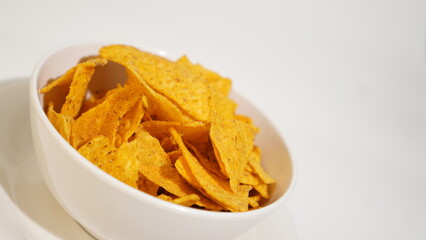 Irresistible bowl of crispy tortilla chips on a pristine white backdrop