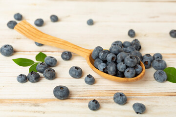 Bowl with fresh blueberries on wooden table