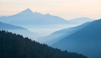 Obraz premium A landscape of blue mountains with a forest in the foreground, fog in the valleys, and a light blue sky