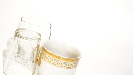Elegant assortment of drinkware featuring glasses and a decorative mug on white