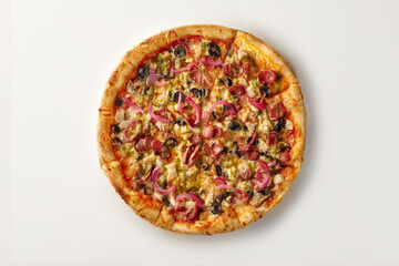 Delicious pizza with pesto, pepperoni, red onion, black olives, and mozzarella cheese on white background
