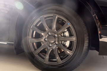 Car wheel with brake calipers and stylish design.