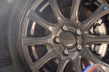Car wheel with brake calipers and stylish design.