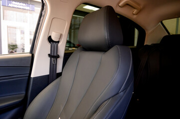 Close up of modern new car interior with black leather seats