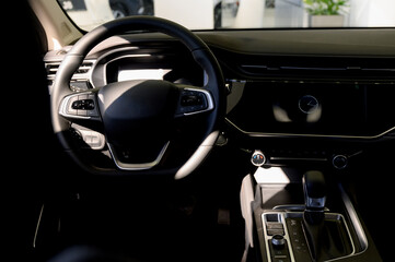 Obraz premium Black steering wheel, automatic transmission,control display in a modern car.