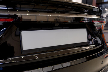 Close-up view of a car's license plate holder with a white background.