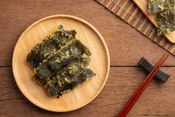 Deep fried Crispy Seaweed with flour and egg.Snack seaweed tempura chips in white plate.Top view.