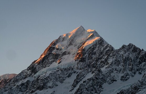 Closeup view of the Mount Cook Aoraki summit alpenglow, highest mountain of New Zealand, seen from the Hooker Valley Track, snow covered Southern Alps