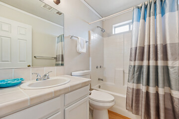A beautifully designed bathroom with two sinks, a tub, and a mirror