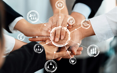 Diverse hands come together in a gesture of teamwork and collaboration, surrounded by connection circles and icons, symbolizing unity and shared goals in a professional environment. Amity