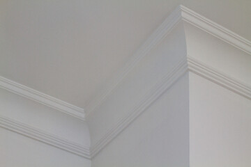 Fototapeta premium A white ceiling corner with decorative crown molding