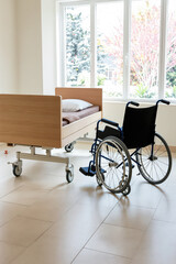 empty hospital room with medical bed and wheelchair