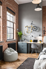 stylish and contemporary bedroom corner with exposed brick walls and a yellow bicycle