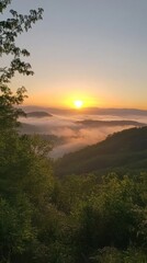 Obraz premium A beautiful sunrise casts a warm light over distant mountains