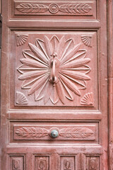 Old wooden carved door with wrought iron details