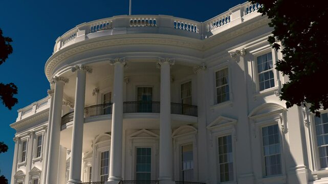 White House at Sunrise &ndash; Movement of Shadows on Historic Facade. Elegant early morning sunlight casts soft, moving shadows across the neoclassical facade of the White House. 3d animation. 4k.