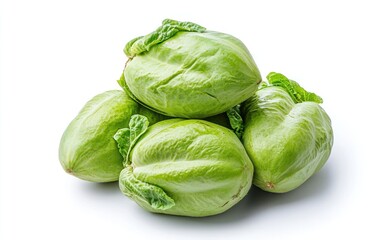 Fototapeta premium Fresh green chayotes arranged on a pristine white background. The chayotes are smooth-skinned and slightly glossy, with small, vibrant green leaves interspersed