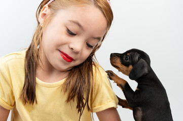 Portrait of kid girl with puppy
