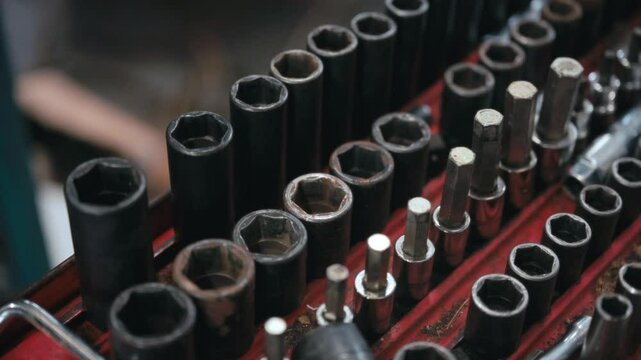 Close up of a set of various sized wrench sockets organized in a toolbox