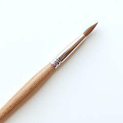 Naklejka premium Fine Artist Brush on a Plain White Background for Creative Art Projects