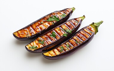 Three grilled eggplant halves arranged on a white background.  Each eggplant is glazed with a dark brown miso sauce and garnished with fresh herbs. The image is brightly lit and has a clean