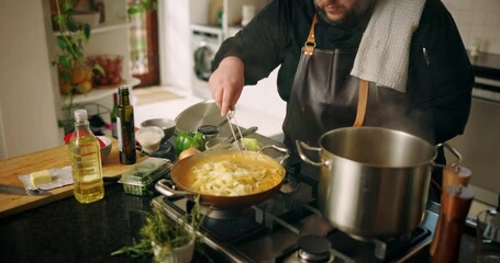 Hands, person and cooking pasta in kitchen with meal preparation, vegan diet and dining at house. Chef, mixing food and nutrition cuisine with healthy ingredients, gourmet recipe and culinary skills