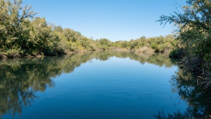 Tranquil oasis in the desert mirrored on glassy water showcasing vibrant blues and lush greens in perfect harmony