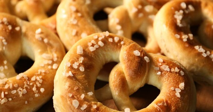 Tasty pretzels on table, closeup. Camera zooming in