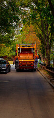 Orange dump truck on a city street wallpaper background