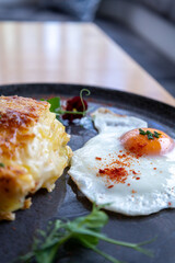 A plate of food with a fried egg and a piece of pie