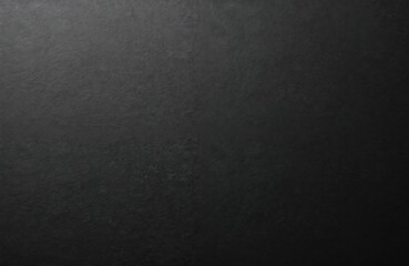 Black paper texture background with rough surface. Blank dark abstract pattern for design, advertising, print. Grunge material for business card, invitation, cover. Empty space for text or graphic.