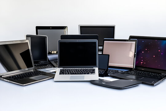 A pile of laptops showcasing technology diversity and potential choices