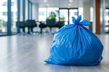 Obraz premium blue garbage bag on the floor in a clean modern office