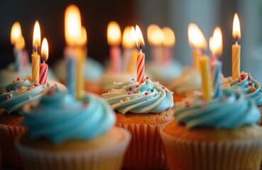 Cupcakes with blue icing, colorful sprinkles, and burning candles on a birthday. Sweet dessert, festive, celebration, bakery, happy moment. Party food, delicious, joy and happiness concept.