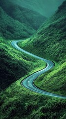 Fototapeta premium Winding road surrounded by lush green hills ascends the valley